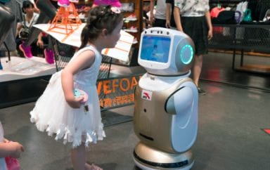 Girl talking to robot in store