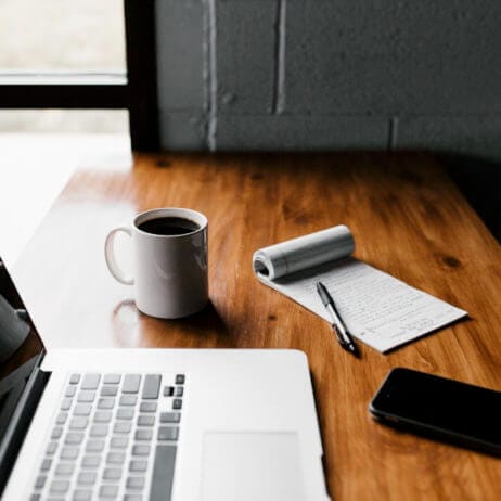 laptop with notepad and coffee